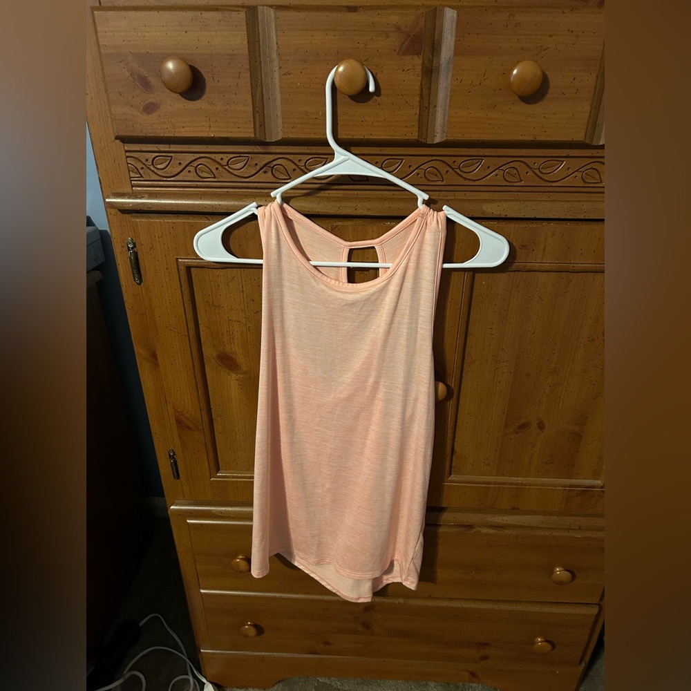 Orange tank top with criss-cross back. New without tags.